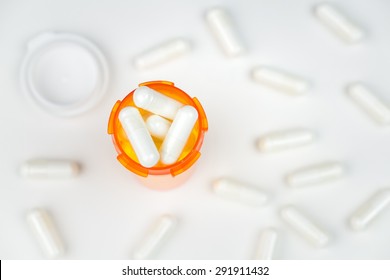 A Prescription Pill Bottle Filled To The Top With Medication, Overhead View