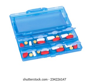 Prescription Pills And Vitamins In A Blue Pill Box - Days Of Week.