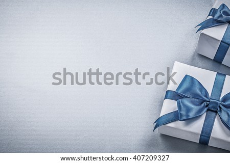 Present boxes on blue background greeting card holidays concept.