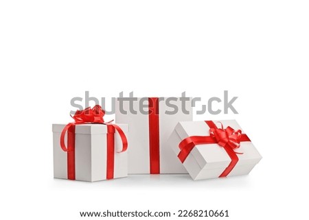Present boxes with red ribbon in different sizes isolated on white background
