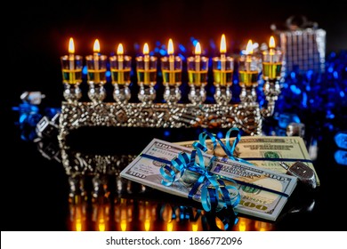 Present Money Next To Menorah With Burning Oil Candles For Hanukkah. Jewish Holiday.