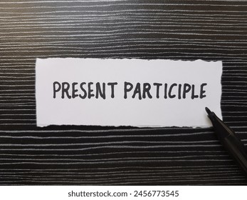 Present participle writting on table background.