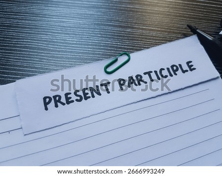 Present participle writting on table background.