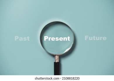 Present wording inside of Magnifier glass on blue background for focus current situation , positive thinking mindset concept. - Shutterstock ID 2108818220