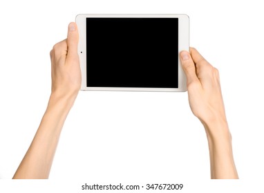 Presentation And Advertising Touchscreen Topic: Human Hand Holding A White Tablet Touch Computer Gadget With Touch Blank Black Screen Isolated On A White Background In The Studio, First-person View