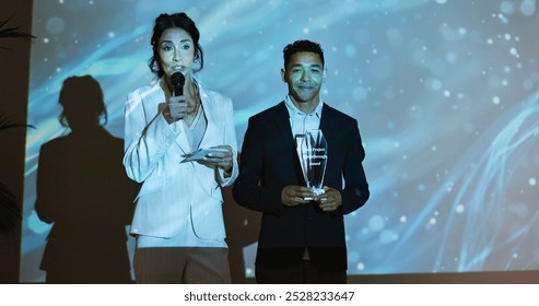 Presentation, conference and business people with award on a stage at tradeshow, convention and seminar. Public speaking, audience and men and women for achievement, thank you and winning at event - Powered by Shutterstock