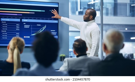 Presentation Event: Black Businesswoman Talks of e-Commerce Product Sales Showing TV Big Data Statistics, Charts, Revenue Growth Infographics. Press Conference for Digital Entrepreneurs, Investors - Powered by Shutterstock