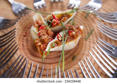 Presentation first plate of pasta shells with meat sauce and tomato