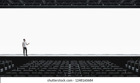 Presentation Hall With Person On Scene Auditorium Watching On Blank Screen Mockup. Empty Display With Speaker Represent Mock Up. Public On Training Or Forum Template.