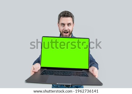 presentation on computer. office manager ready for video conference. amazed man showing green laptop screen. copy space. webinar pc advertisement. businessman presenting product. success.