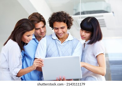 Presentation and teamwork - Technology. A group of young entrepreneurs having a business meeting over a laptop.