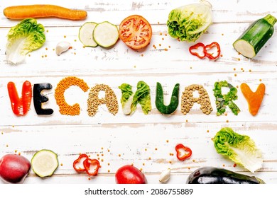 Presentation of vegan diet month in january called Veganuary. Flat lay on white rustic wooden background - Shutterstock ID 2086755889