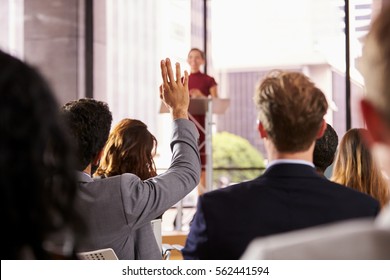 Presenter at business seminar takes a question from audience