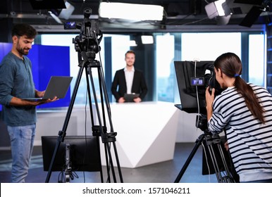 Presenter, Director And Video Camera Operator Working In Studio. News Broadcasting