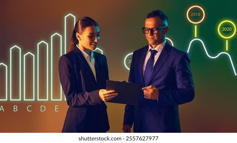 Presenter highlights growth and declines in market trends with colorful bar chart as backdrop. Concept of presentation, training, meeting, leadership, analysis. Copy space for ad. - Powered by Shutterstock