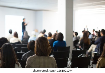 Presenter Presenting Presentation to Conference Audience. De-focused Blurred . Lecturer on Stage at Tech Forum. Speaker Giving Speech in Conference Hall Auditorium. Copy Space Screen Background. - Shutterstock ID 1261021294