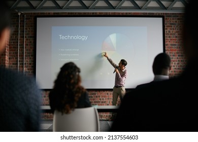 Presenting key notes to his colleagues. Shot of a businessman giving a presentation to his colleagues.