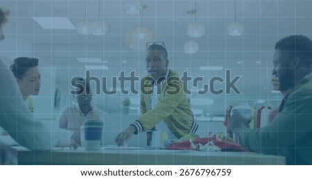 Presenting man in bomber jacket addressing team at office meeting table, with laptop and papers. Collaboration, teamwork, businessdiscussion, modernoffice, professionalenvironment, corporateculture,