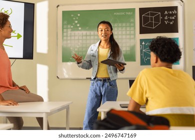 Presenting project in high school, teenage girl holding tablet with classmates watching. Education, presentation, teamwork, learning, technology, high high school - Powered by Shutterstock