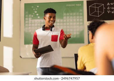 Presenting project, teenage boy with tablet smiling in high school classroom. Education, student, technology, learning, presentation, academic - Powered by Shutterstock