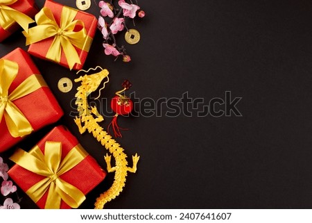 Presents for welcoming the Lunar New Year. Top view photo of gold dragon, present boxes, traditional coins, sakura, lanterns on black background with promo zone