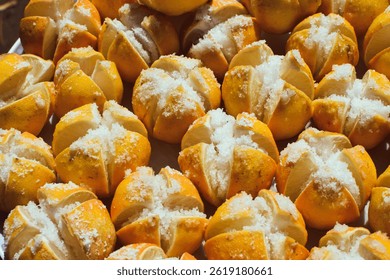 Preserved Lemons processing under sun. lime pickles in a plate, lime preserving process with salt, close up view taken from above, Preserving lime with salt, Preserved Lemons