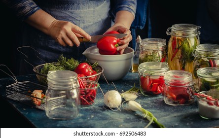 Preserved Red Bell Peppers Process Fermented In Glass Jars Kitchen Table Hand Vegetarian Canning Food Concept Toned Image 