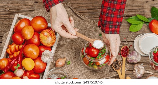 Preserved season vegetable concept. Harvest of tomato, chili, greens, onion and garlic. Woman's hands prepare ingredients for canned food, cooking process. Healthy recipes, home cuisine, banner format - Powered by Shutterstock