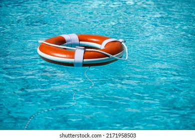 Preserver Lifebuoy. Orange Lifebuoy In Sea On Water. Life Ring Floating Of Water.