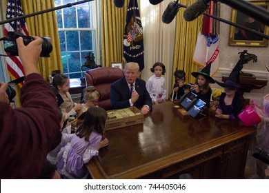 President Donald Trump poses for pictures with the children of White House journalists in the Oval Office, Friday, October 27, 2017.