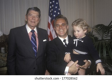 President Ronald Reagan And An Admirer Holding A Child