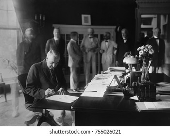 President Warren Harding signing a bill into law, in the White House Oval Office. August 18, 1922.