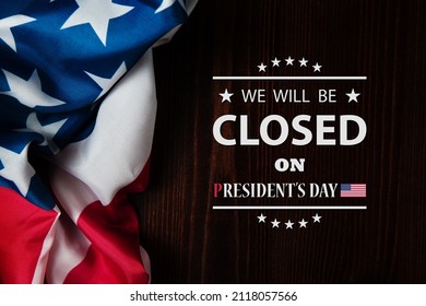 President's Day Background Design. American flag on a wooden table with a message. We will be Closed on President's Day.