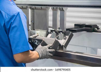 The press brake hydraulic bending  machine operation,bending the automotive by  skill worker. The sheet metal manufacturing process by bending machine with technician operator. - Powered by Shutterstock