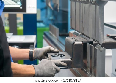 The press brake hydraulic bending  machine operation,bending the automotive by  skill worker. The sheet metal manufacturing process by bending machine with technician operator. - Powered by Shutterstock