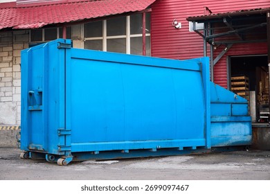 Press Container Compactor for Reducing Volume in yard of large hypermarket mall. Press Container Compactor for Reducing Volume of Municipal and Industrial Waste. Waste recycling concept.