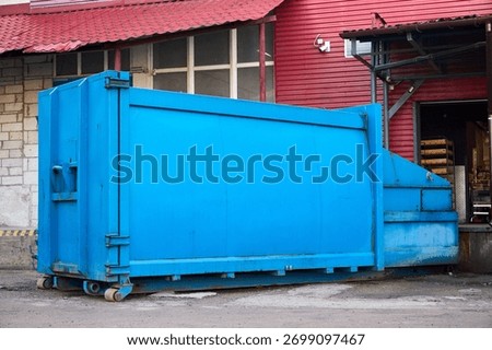 Press Container Compactor for Reducing Volume in yard of large hypermarket mall. Press Container Compactor for Reducing Volume of Municipal and Industrial Waste. Waste recycling concept.