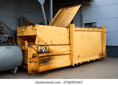 Press Container waste Compactor machine for Reducing Volume in yard of large hypermarket mall. Press Container Compactor for Reducing Volume of Municipal and Industrial Waste. Waste recycling concept.