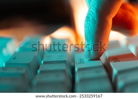 Press enter button on a keyboard with orange and teal light