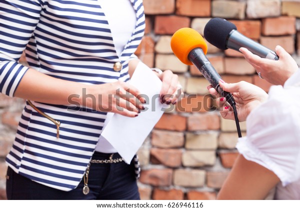 Press interview.\
News conference.\
Microphones.