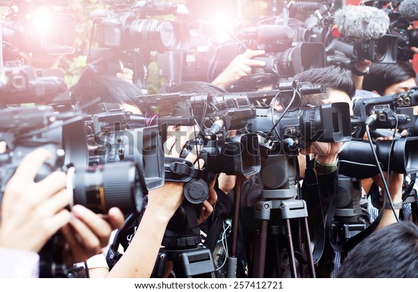 press and media \
photographer on duty in public news coverage event for reporter and\
mass communication