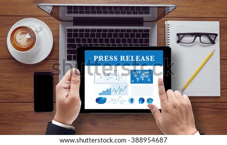 Press Release  concept on the tablet pc screen held by businessman hands, top view