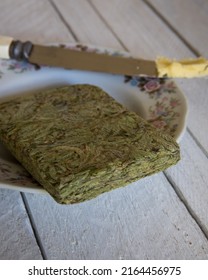 Pressed Cannabis Flower For The Rosin Press Pictured Here On A Plate With A Knife And Butter Like Toast