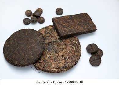 Pressed pancakes and bricks of puer tea of different kinds. Dry Chinese tea of high quality. White tea in pressed pancake on a white background. Tasty and healthy drinks for health.