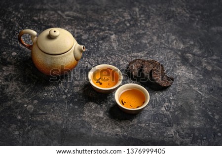 pressed pu-erh Chinese tea, cups of tea and teapot. Asia culture design concept. tea ceremony, Chinese or japanese traditions. copy space