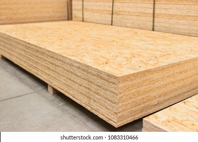 Pressed wooden osb panel. Background texture of wooden OSB board butt ends stacked, close up. - Shutterstock ID 1083310466