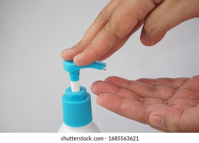 pressing bottle handle to sanitize virus and germ on hand - Shutterstock ID 1685563621