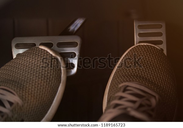 Pressing\
brake and accelerator car pedals close up\
view