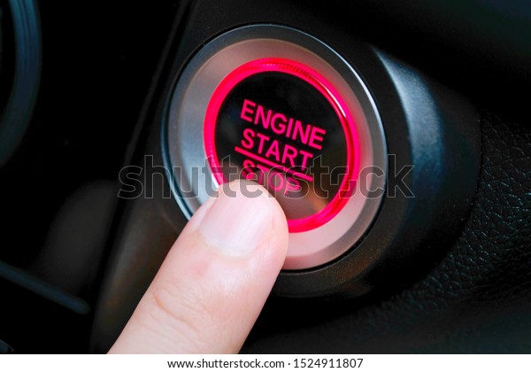Pressing the car start button. Concept of\
transportation and\
technology