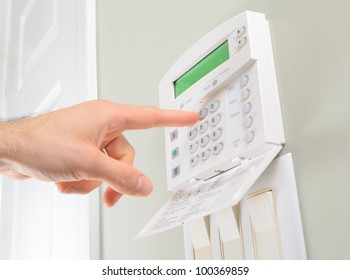 pressing the code on a house alarm